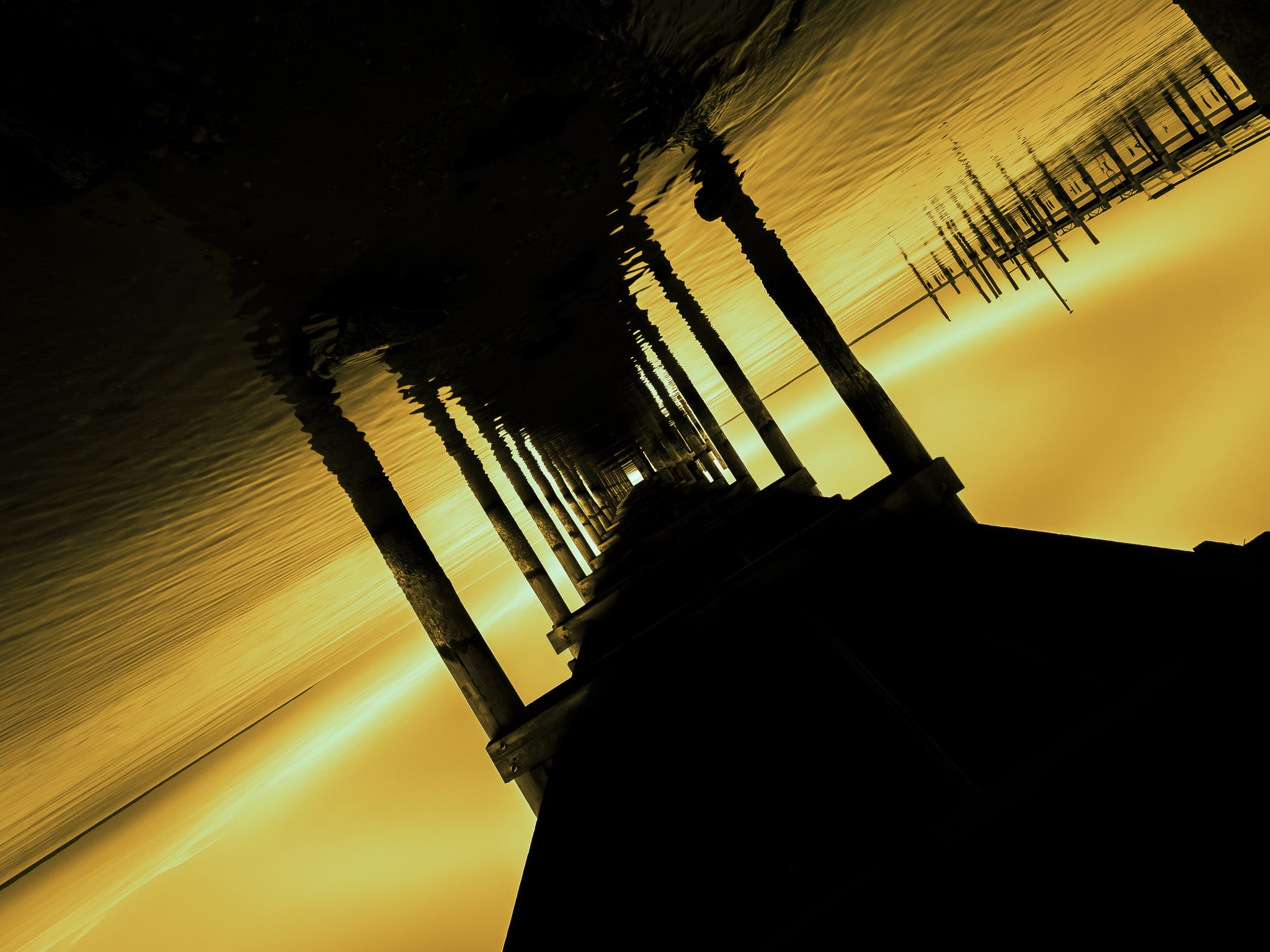Silhouette of a reflective surface, water, at sunset.