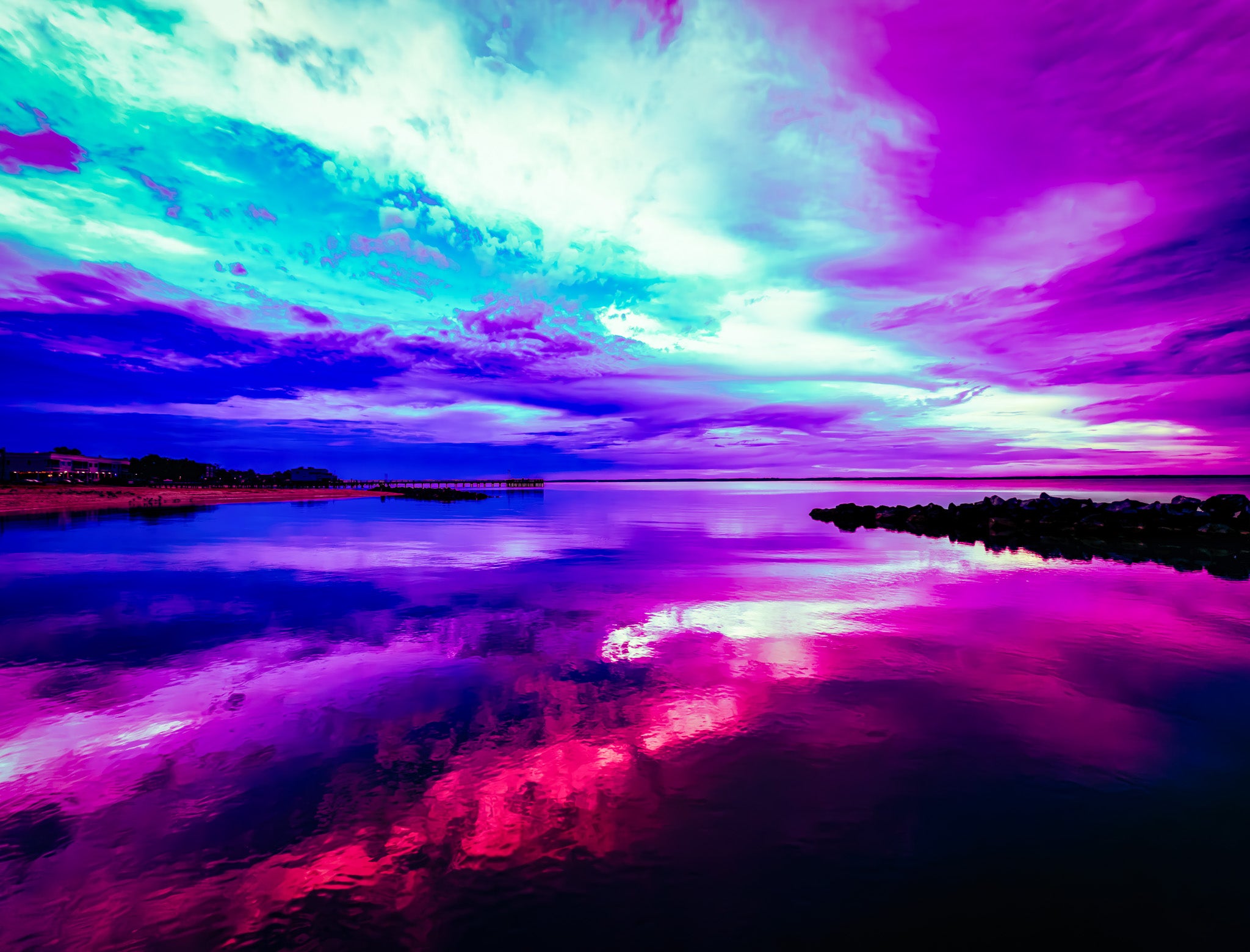 Colorful sunset over a pier with reflection on water. Untitled — The Sky Isn’t Falling…Yet 011 by Austin Red. Pink and purple sky-and-water photography with reflection and a long pier, produced with WhiteWall using gallery-grade materials.”